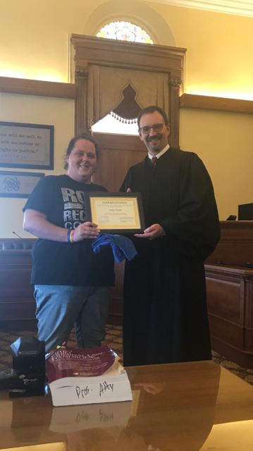 Judge handing over certificate of graduation