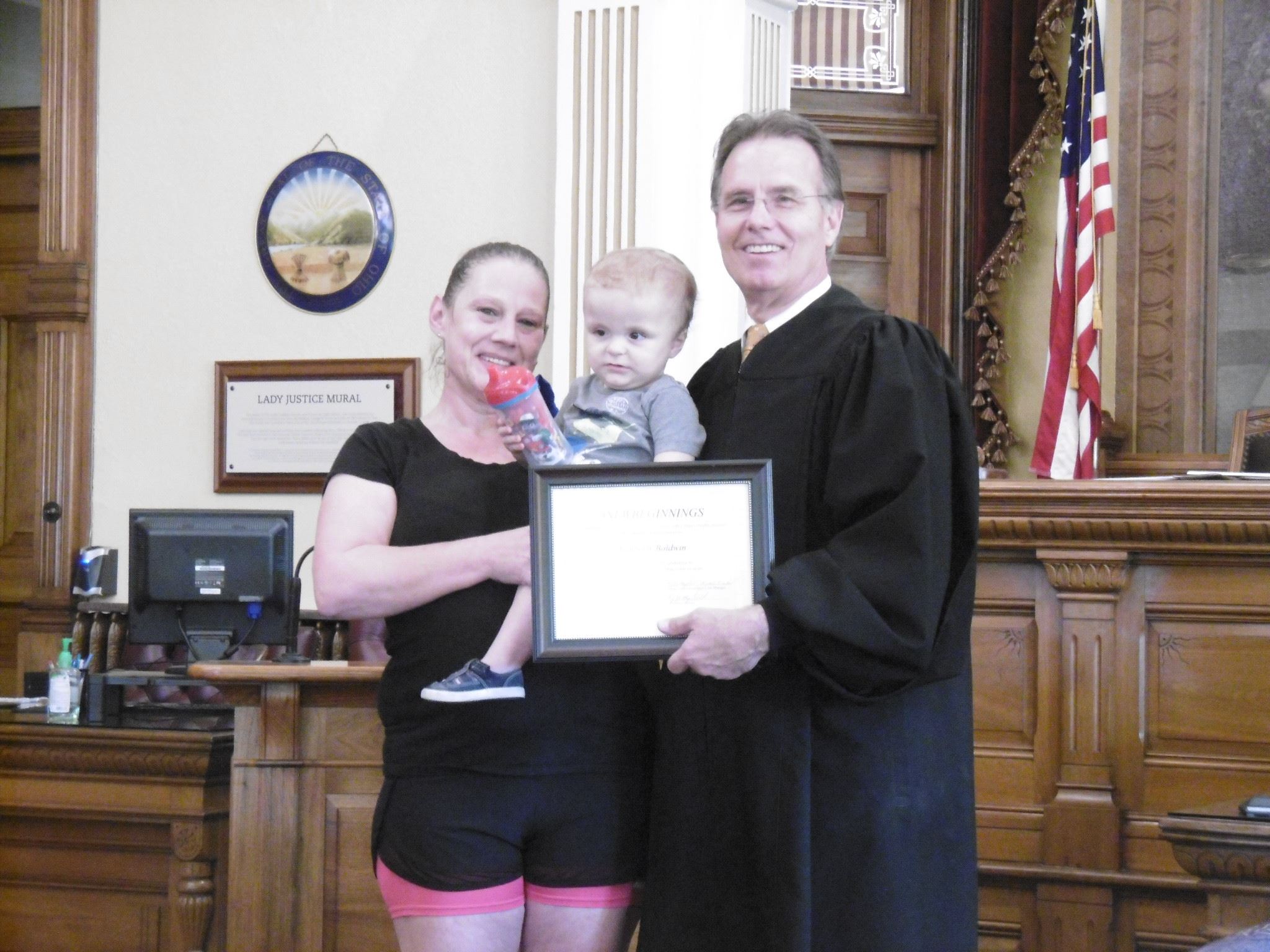 Mother holding child at graduation